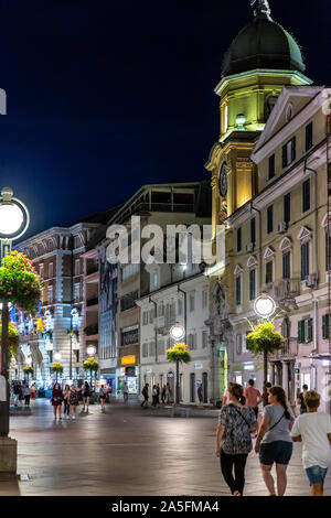 The Korzo pedestrian shopping zone and city clock tower in  the evening. Rijeka city centre, Croatia, 2019 Stock Photo
