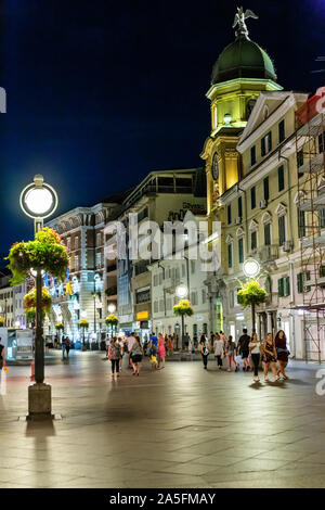 The Korzo pedestrian shopping zone and city clock tower in  the evening. Rijeka, Croatia, 2019 Stock Photo