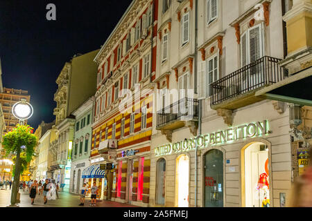 Colourful modern shops occupy the lower floors of the colourful buildings on the Korzo (Rijeka's pedestrian shopping zone). Stock Photo