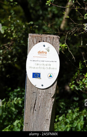 A sign listing the sources of funding for the construction of the Strawberry Line, a long-distance footpath on a disused railway line in Somerset, UK. Stock Photo