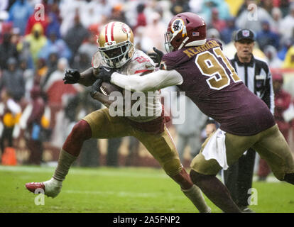 Landover, Maryland, USA. 20th Oct, 2019. San Francisco 49ers running back Tevin Coleman (26) tries to elude Washington Redskins outside linebacker Ryan Kerrigan (91) in fourth quarter action at FedEx Field in Landover, Maryland on Sunday, October 20, 2018. The 49ers won the game 9 - 0 Credit: Ron Sachs/CNP/ZUMA Wire/Alamy Live News Stock Photo