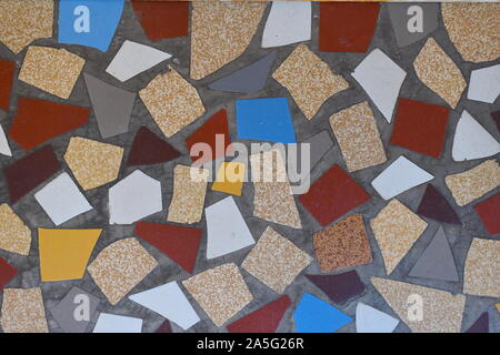 Colourful tiles in the old town centre in south of France. Red, blue, grey, brown, yellow, white mosaic tiles found on the alleyways in Europe. Stock Photo