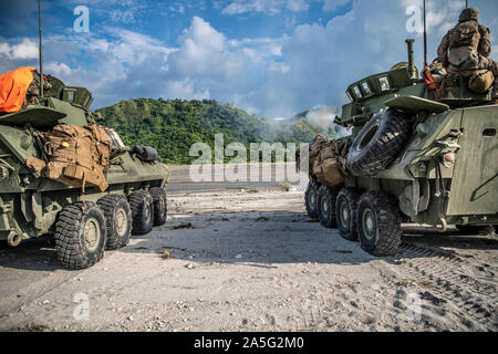 Light armored vehicles with Alpha Company, Battalion Landing Team 3/5, 11th Marine Expeditionary Unit, and Alpha Company, temporarily assigned from 3rd Light Armored Reconnaissance Battalion to 3rd Marine Division, fire their main guns during exercise KAMANDAG 3 at Colonel Ernesto Ravina Air Base, Philippines, Oct. 11, 2019. KAMANDAG advances military modernization and capability development through subject matter expert exchanges. (U.S. Marine Corps photo by Sgt. Adam Dublinske) Stock Photo