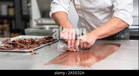 Making handmade chocolates. A confectioner making chocolate sweets. Close-up . Stock Photo