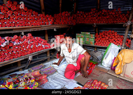 Champahati, India. 20th Oct, 2019. A trader waits for customer in his fire cracker shop in Champahati.Champahati is the Largest Fireworks market in West Bengal, India from where Millions of Fireworks get supplied all over India for celebration. The market produced Turnover (Rs in Million's), 425 million/ year as per Government's Small scale industries data. Credit: SOPA Images Limited/Alamy Live News Stock Photo