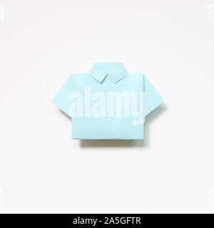 Blue paper shirt origami on white background Stock Photo