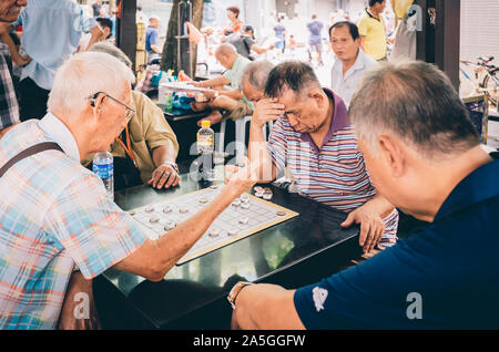 Singapore-09 JUN 2018:Chinese old man play traditional chess in the Singapore China town open plaza Stock Photo