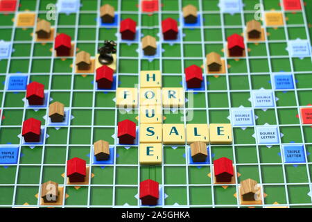 House For Sale - The image taken with conceptual photograph of written words and small mini wooden house look like blocks to fill the column. Stock Photo