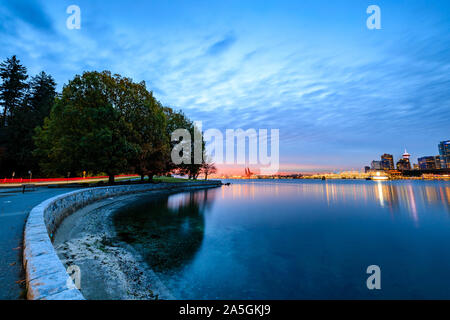 Light trail along Vancouver seawall during October sunrise Stock Photo