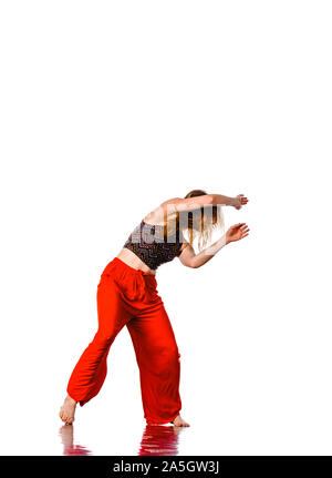 Aerobics woman. Portrait of pretty smiling girl training dance on studio background Stock Photo