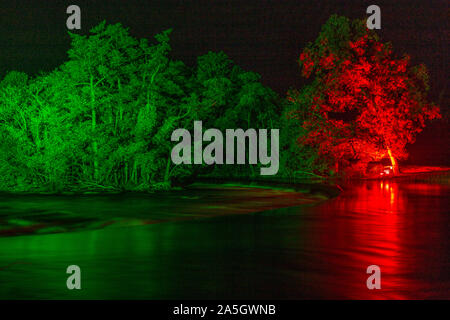 Night time illuminations of trees and river at Horseshoe Falls, River Dee, Llangollen, North Wales Stock Photo