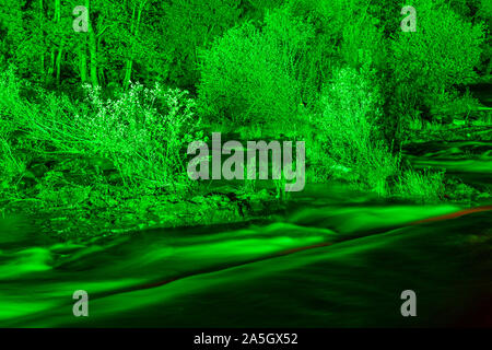 Night time illuminations of trees and river at Horseshoe Falls, River Dee, Llangollen, North Wales Stock Photo