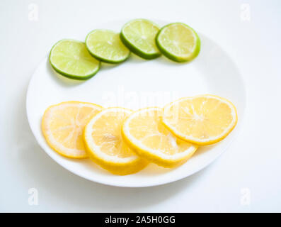 lemon and lime on a white plate Stock Photo