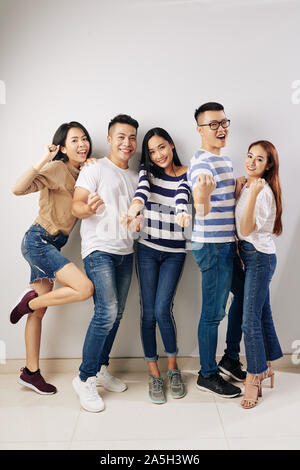 Full-length portrait of young Vietnamese people posing for photo in studio Stock Photo