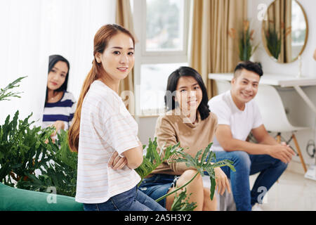 Group of office workers gathering in lounge area to discuss news and ideas Stock Photo