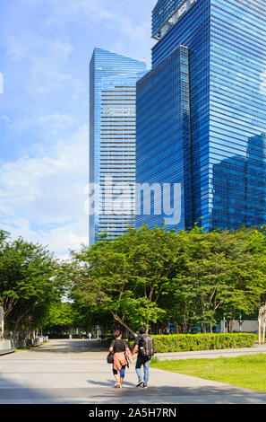 Singapore-05 MAY 2018: couple walking in the Singapore CBD park Stock Photo