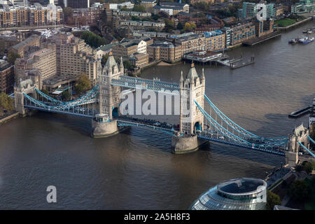 An aerial view looking down on Tower Bridge across the River Thames in London, England.