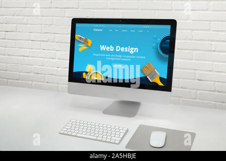 Web design studio concept with modern computer display with web design web site theme concept. Stock Photo