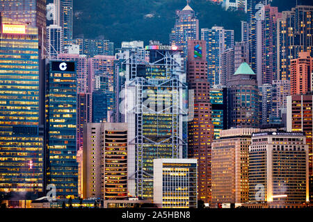 Modern high-rise buildings at Central Waterfront illuminated at night. Hong Kong, China. Stock Photo