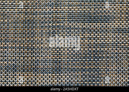 Close-up of black and orange synthetic fabric texture. membrane fiber structure. weaving pattern of interwoven fibers. fiber braided background. Stock Photo