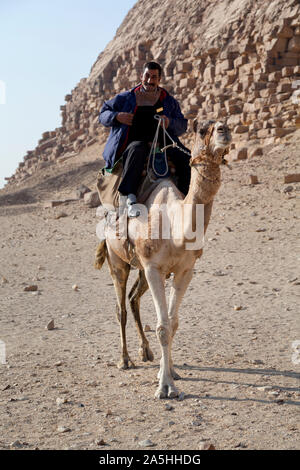 Egypt, Dashir, Sneferu's Bent Pyramid and a tourist policeman on his camel. Stock Photo