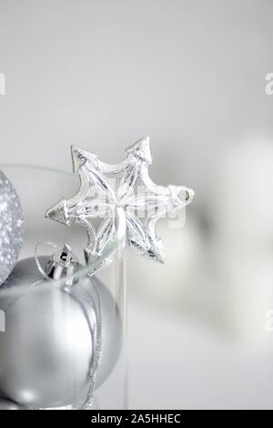 Holidays Festive Silver Ornaments, White Candles. Minimal Christmas Decorations. Home Decor for Winter. Stock Photo