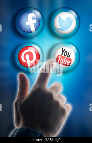 hand touching and choosing from various social media logos Stock Photo