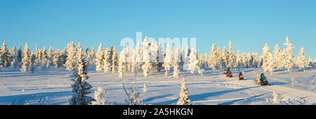Group of snowmobiles in Lapland, near Saariselka, panoramic winter background, Finland Stock Photo