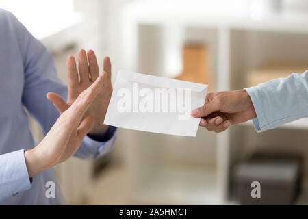 Close up cropped image honest businessman rejecting taking envelope. Stock Photo