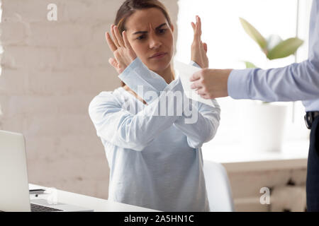 Angry millennial mixed race woman rejecting taking bribe. Stock Photo