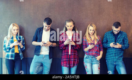 Young hipster people addicted by mobile smart phone and social media Stock Photo