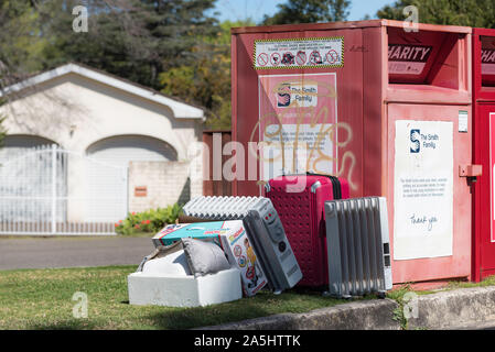 Consumer goods dumped beside a charity bin in a Sydney suburb. Charities spend millions of dollars every year disposing dumped waste Stock Photo