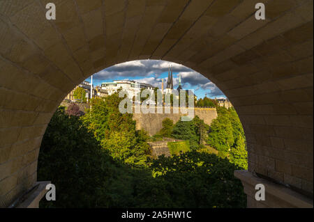 Luxembourg city seen through an arch of Adolphe Bridge, Grand Duchy of Luxembourg Stock Photo