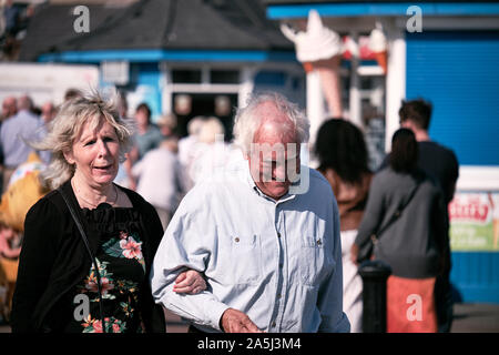 Senior couple out for a walk on a sunny autumn day on the pier of Llandudno Wales Stock Photo