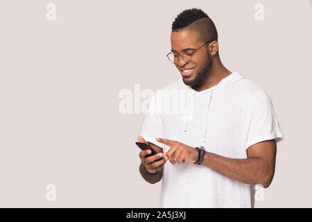 Smiling biracial man using modern cellphone with wireless internet Stock Photo