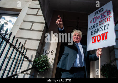 London, UK. 19th Oct, 2019. A man pretending to be Boris Jonhson holds an Anti Brexit placard while making a gesture during the protest.A few days before the Brexit becomes a reality, one of the biggest public protests in British history took place in London. More than a million people participated in mass outside parliament to deliver a message loud and clear to the Government and MPs that they should trust the people, not Boris Johnson, to solve the Brexit crisis. Credit: Ana Fernandez/SOPA Images/ZUMA Wire/Alamy Live News Stock Photo