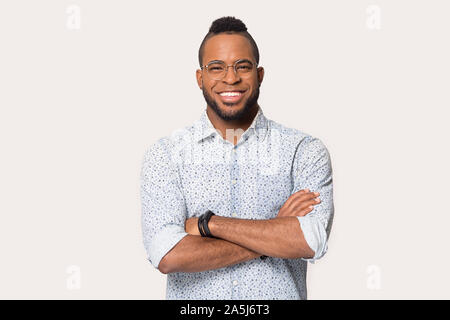 Smiling african American man in glasses posing in studio Stock Photo