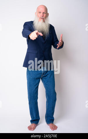 Full body shot of mature bearded bald businessman pointing at camera Stock Photo