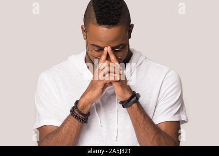 Pensive african american man lost in thoughts having dilemma Stock Photo