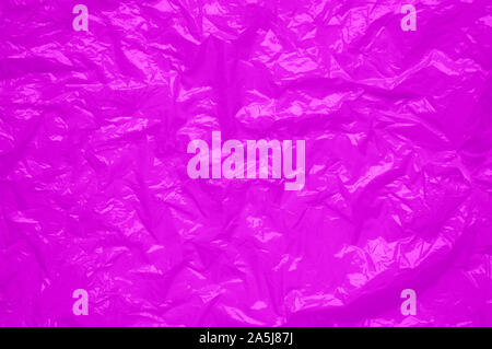 Pink cellophane sheet with shiny crumpled texture. abstract neon background Stock Photo