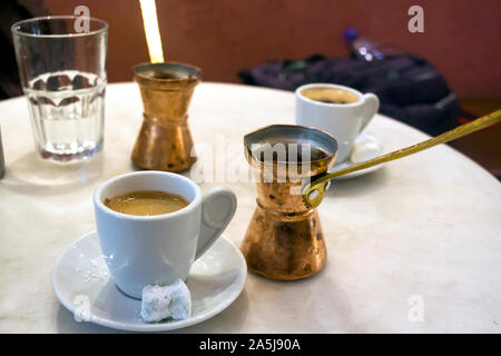 Copper coffee pots and greek coffe, sweet loukoumi on the small dish. Taken in Athens Stock Photo