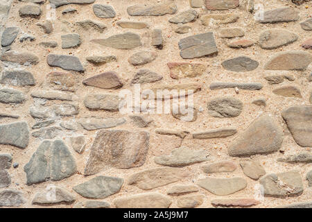 Irregular, old stones creating warm, natural background Stock Photo