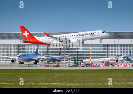 Munich, Germany - September 18. 2019 : Helvetic Airways Embraer ERJ-190 with the aircraft registration HB-JVU  approaching to the southern runway 08R Stock Photo