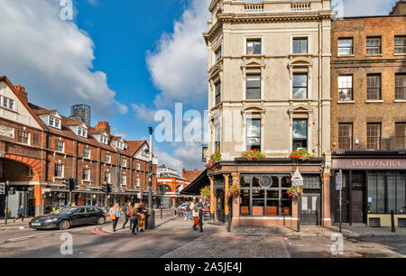 LONDON SPITALFIELDS COMMERCIAL STREET OLD SPITALFIELDS MARKET BUILDING AND OPPOSITE THE TEN BELLS PUBLIC HOUSE IN FOURNIER STREET Stock Photo