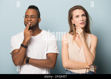 Pensive multiethnic man and woman thinking over dilemma Stock Photo
