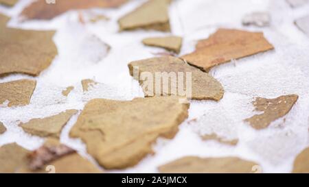 Snow covered wild stone paving tiles, winter pavement background Stock Photo