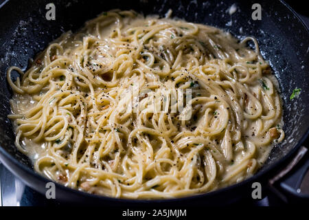 Pasta Spaghetti in Pan with Four Cheese Parmesan, Roquefort, Gravy, Gorgonzola, Cream and Garlic and Ground Pepper. Traditional Italian Food. Stock Photo