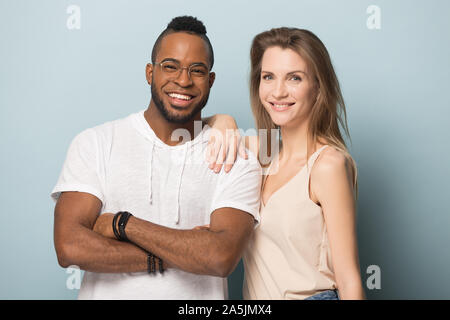 Portrait of smiling multiracial couple posing in studio Stock Photo