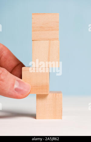 Cubes made of wood on a blue background. Concept of change and new plan. Close up. Vertical. Stock Photo