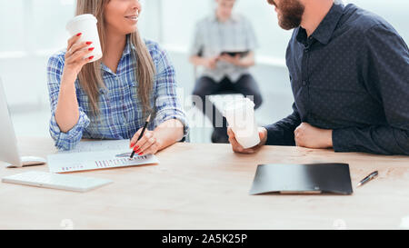 young employees discussing financial documents during coffee break. office weekdays Stock Photo
